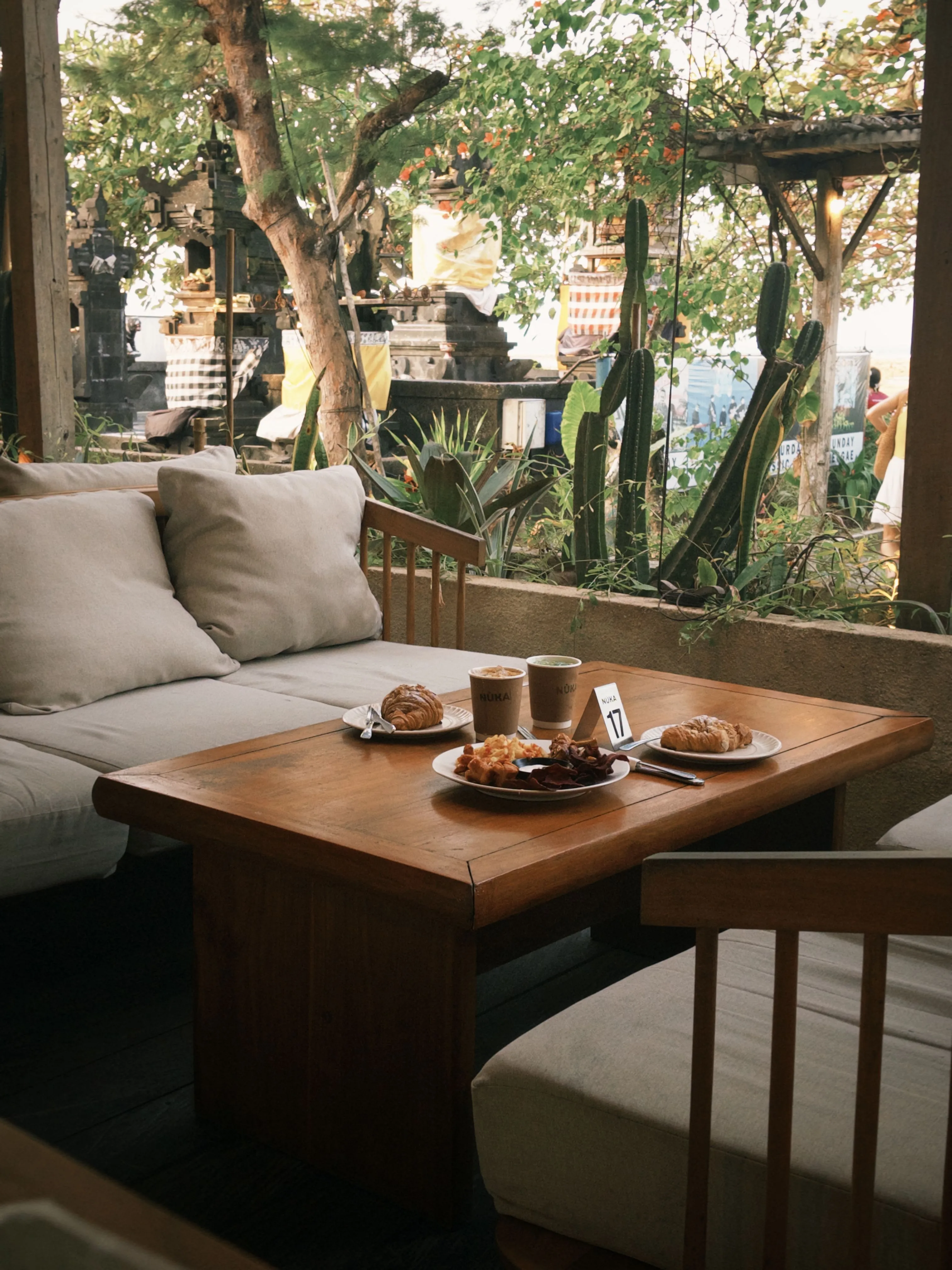 A café terrace table set with coffee and pastries.